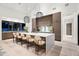 Modern kitchen with waterfall island, pendant lighting, and seating for six at 8255 E Morgan Trl, Scottsdale, AZ 85258
