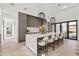 Kitchen island with counter seating, stylish pendants, and modern cabinets at 8255 E Morgan Trl, Scottsdale, AZ 85258