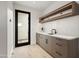 Contemporary mudroom with custom cabinets, countertop, sink, and wooden flooring offers practical elegance at 8255 E Morgan Trl, Scottsdale, AZ 85258