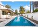 Refreshing pool surrounded by patio area and landscaping, creating a private backyard oasis at 8255 E Morgan Trl, Scottsdale, AZ 85258