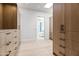 Stylish walk-in closet with custom wood cabinetry and a view into the bathroom, creating a spa-like retreat at 8255 E Morgan Trl, Scottsdale, AZ 85258