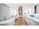 Bright bathroom boasts double sinks, a free-standing tub, and views into bedroom at 8277 E Tailspin Ln, Scottsdale, AZ 85255