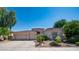 Single-story home with a two-car garage and landscaped yard at 8277 E Tailspin Ln, Scottsdale, AZ 85255