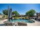 Inviting backyard oasis with a kidney-shaped pool and lounge chairs at 8277 E Tailspin Ln, Scottsdale, AZ 85255