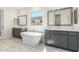 Elegant bathroom with double vanity, freestanding soaking tub, and gray cabinets at 8569 N 175Th Ln, Waddell, AZ 85355