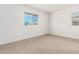 Well-lit bedroom featuring neutral walls and carpet at 8569 N 175Th Ln, Waddell, AZ 85355