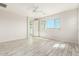 Spacious bedroom with ceiling fan, large window, and wood-look tile flooring at 8569 N 175Th Ln, Waddell, AZ 85355