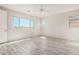 Well-lit bedroom featuring a ceiling fan and wood-look tile flooring at 8569 N 175Th Ln, Waddell, AZ 85355