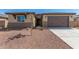 New construction home with two-car garage and desert landscaping at 8569 N 175Th Ln, Waddell, AZ 85355