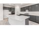 Modern kitchen with gray cabinetry, white quartz island, and stainless steel appliances at 8569 N 175Th Ln, Waddell, AZ 85355