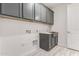 Laundry room featuring built-in cabinets and a utility sink at 8569 N 175Th Ln, Waddell, AZ 85355