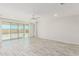 Bright living room with sliding glass doors and wood-look tile floors at 8569 N 175Th Ln, Waddell, AZ 85355