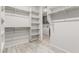 Spacious walk-in closet with ample shelving and hanging rods at 8569 N 175Th Ln, Waddell, AZ 85355