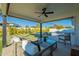 Covered patio with seating area overlooking the pool and grassy yard at 8732 E Valley Vista Dr, Scottsdale, AZ 85250