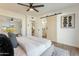 Modern bedroom with barn door to bathroom and stylish decor at 8732 E Valley Vista Dr, Scottsdale, AZ 85250