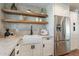 Modern kitchen with white cabinets and floating shelves at 8732 E Valley Vista Dr, Scottsdale, AZ 85250