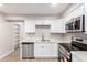 Modern kitchen with white cabinets and stainless steel appliances at 874 E Tyson St, Chandler, AZ 85225