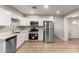 Modern kitchen with white cabinets, stainless steel appliances, and quartz countertops at 874 E Tyson St, Chandler, AZ 85225