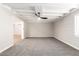 Living room with exposed beams, ceiling fan, and brick feature wall at 874 E Tyson St, Chandler, AZ 85225