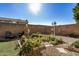 Landscaped backyard with garden beds and a birdhouse at 8805 W Windrose Dr, Peoria, AZ 85381