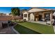 Artificial turf, covered patio, fire pit, and garden at 8805 W Windrose Dr, Peoria, AZ 85381