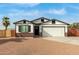 Charming craftsman style home with a white exterior, brick base, and attached two-car garage at 902 S 96Th St, Mesa, AZ 85208