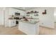 Modern kitchen featuring white shaker cabinets, granite countertops, and a large island at 902 S 96Th St, Mesa, AZ 85208