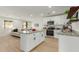 Open concept kitchen with island, white cabinets, and stainless steel appliances at 902 S 96Th St, Mesa, AZ 85208