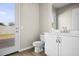 Clean bathroom with modern vanity and a door leading outside at 10229 N 177Th Dr, Waddell, AZ 85355