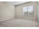 Bright bedroom with a window and neutral decor at 10229 N 177Th Dr, Waddell, AZ 85355