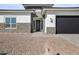 Front entrance with stone veneer and a metal door at 10229 N 177Th Dr, Waddell, AZ 85355