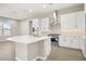 Modern kitchen with white cabinets, stainless steel appliances, and an island at 10229 N 177Th Dr, Waddell, AZ 85355