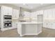 Modern kitchen with white cabinets, large island, and stainless steel appliances at 10229 N 177Th Dr, Waddell, AZ 85355