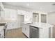 Modern kitchen island with white cabinets and stainless steel appliances at 10229 N 177Th Dr, Waddell, AZ 85355