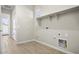 Laundry room with built-in shelving and tile flooring at 10229 N 177Th Dr, Waddell, AZ 85355