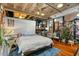 Spacious bedroom with exposed brick and hardwood floors at 114 W Adams St # 203, Phoenix, AZ 85003