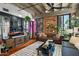 Living room with exposed brick, hardwood floors, and comfy seating at 114 W Adams St # 203, Phoenix, AZ 85003