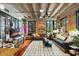 Spacious living room with exposed brick, hardwood floors, and stylish furnishings at 114 W Adams St # 203, Phoenix, AZ 85003