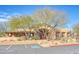 Community building with stucco exterior, landscaping, and parking at 11500 E Cochise Dr # 2019, Scottsdale, AZ 85259