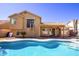 Stunning backyard featuring a pool, covered patio, and a spiral staircase to a second-floor balcony at 11825 S 46Th St, Phoenix, AZ 85044