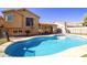 Expansive backyard showcasing a sparkling pool, covered patio, and lush landscaping at 11825 S 46Th St, Phoenix, AZ 85044