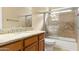 Bright bathroom featuring a granite vanity top and tiled shower-over-tub at 11825 S 46Th St, Phoenix, AZ 85044