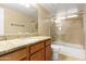 Bright bathroom featuring a granite vanity top and tiled shower-over-tub at 11825 S 46Th St, Phoenix, AZ 85044