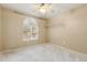 Neutral bedroom with a ceiling fan, carpet, and natural light from the window at 11825 S 46Th St, Phoenix, AZ 85044