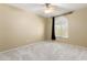 Neutral bedroom with a ceiling fan, carpet, and natural light from the window at 11825 S 46Th St, Phoenix, AZ 85044