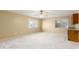 Large bonus room with a ceiling fan, carpet, and wet bar with a granite countertop at 11825 S 46Th St, Phoenix, AZ 85044