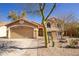 Charming single-story home with a two car garage, xeriscaped front yard and beige exterior at 11825 S 46Th St, Phoenix, AZ 85044