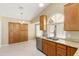 Well-lit kitchen featuring granite countertops, stainless steel appliances, tile floors and an abundance of cabinet space at 11825 S 46Th St, Phoenix, AZ 85044