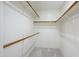 Walk-in closet with carpet floors and wood racks for storing clothes at 11825 S 46Th St, Phoenix, AZ 85044