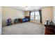 Bright bedroom with carpeted floor, window, and ceiling fan at 12222 W Planada Ln, Sun City, AZ 85373